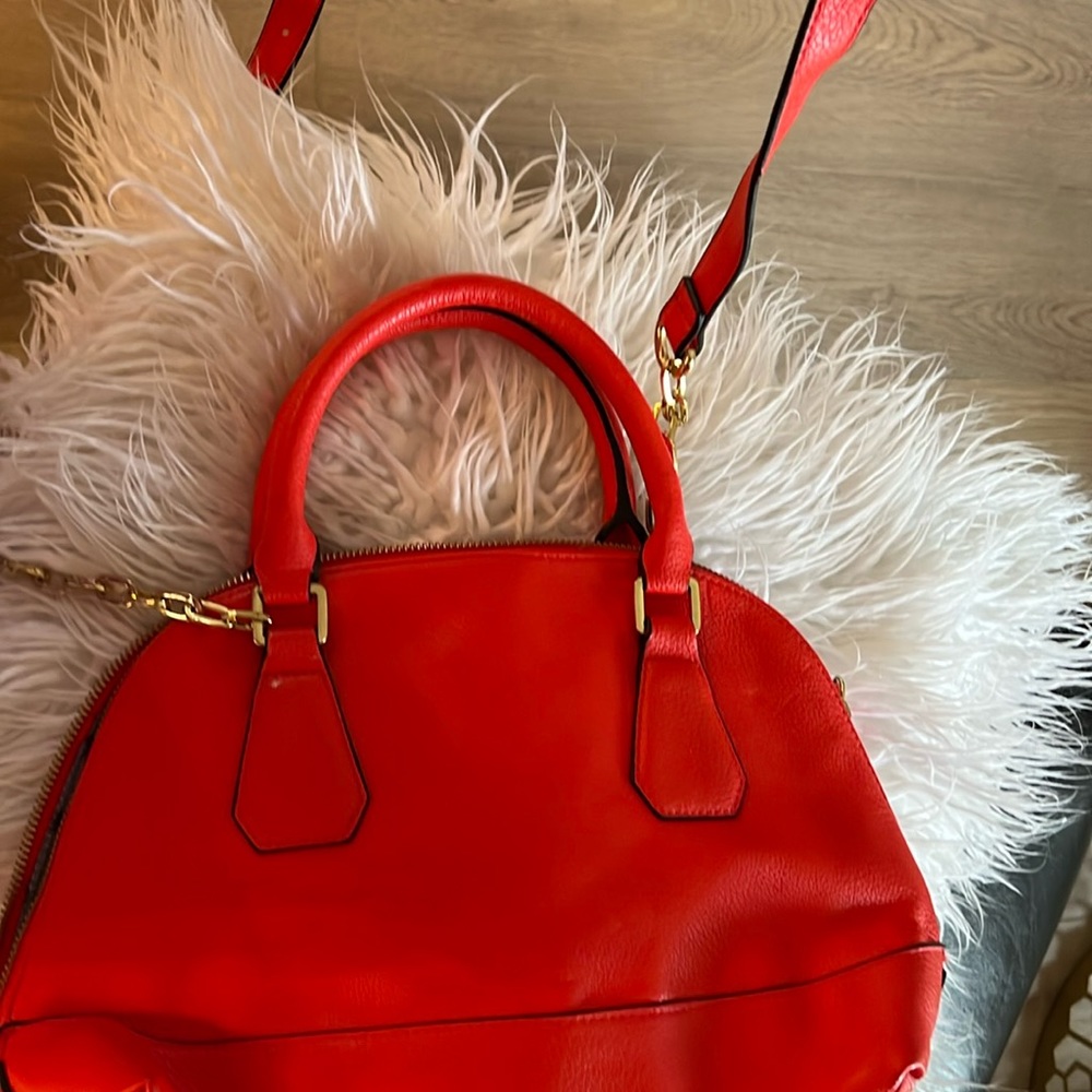 Cute bright orange bag.  Wear it as a crossbody or grab it by the handle.
